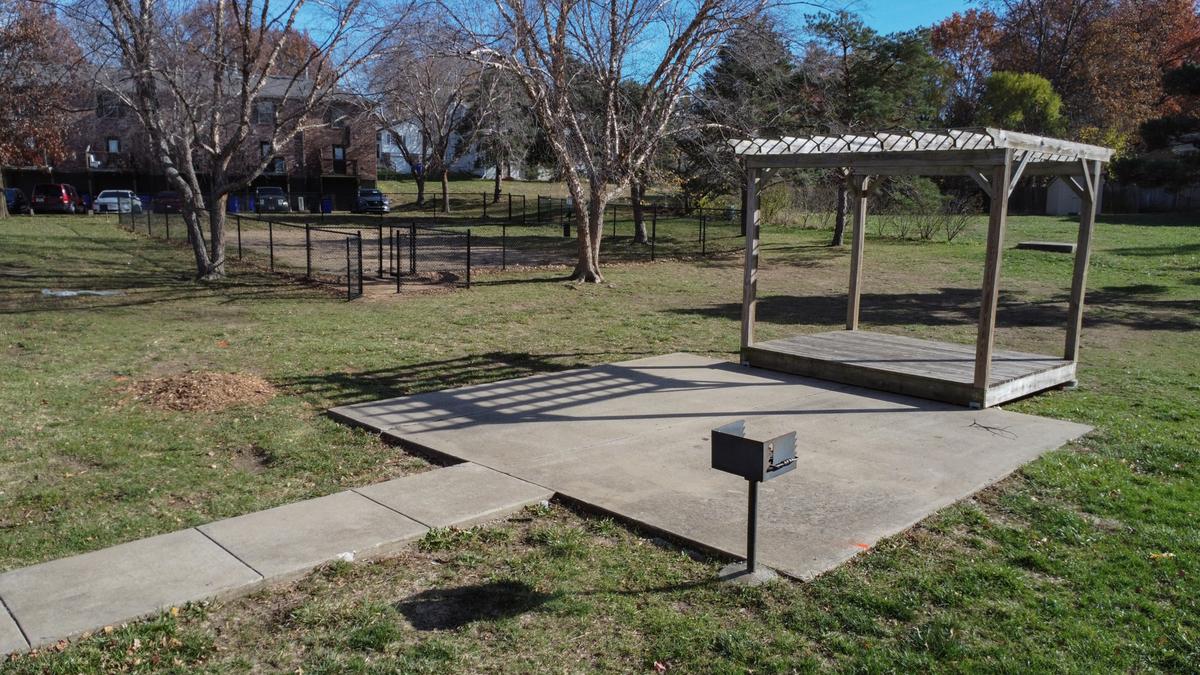 A park with a gazebo and a mailbox.