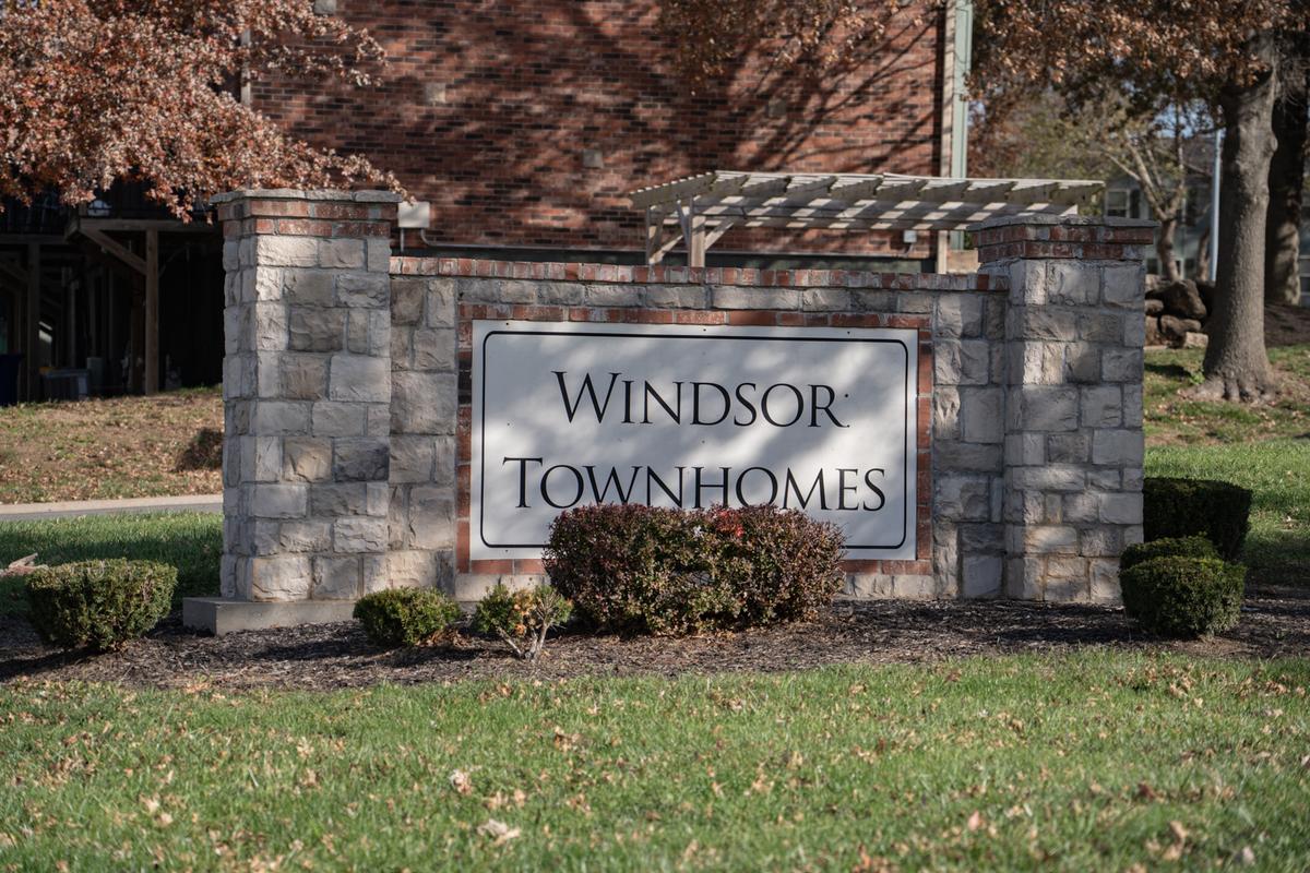 A sign that says Windsor Townhomes in front of a building.